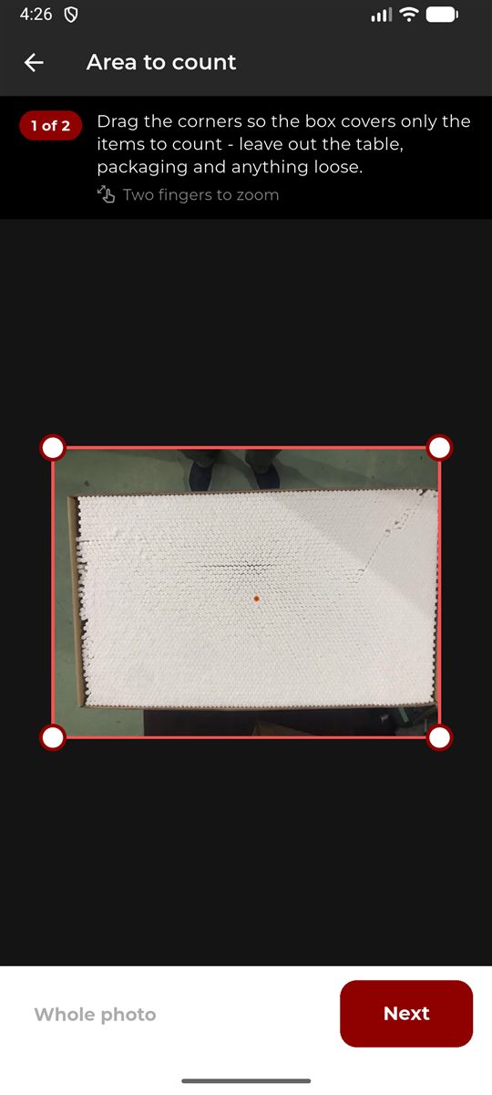 Drawing a box around a carton of cigarette filters to mark the area to count